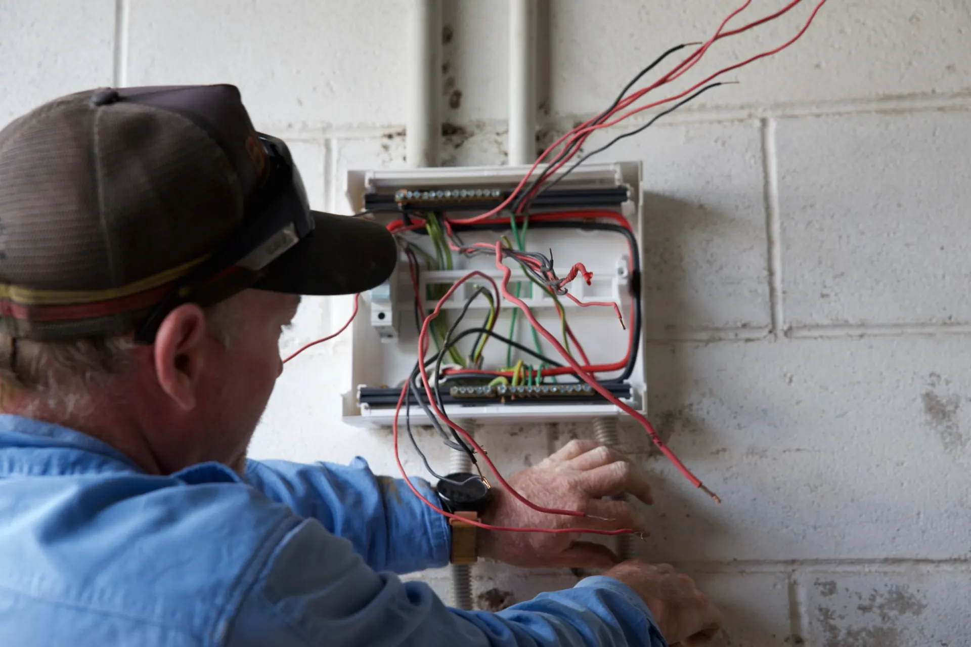 Wiring the new switchboard in the shed, with safety switches on the light and power circuits.