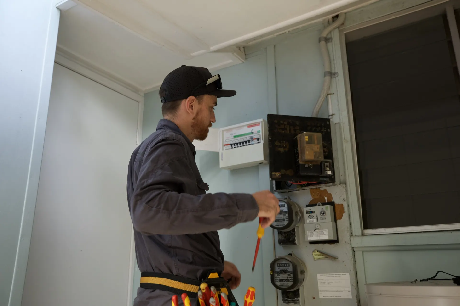 The old meter board inside the house, with the separate safety switch board beside it.