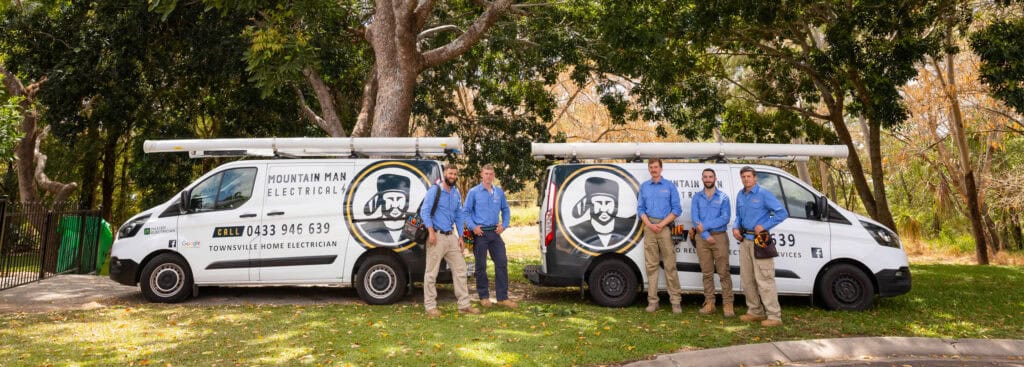 A group of installers from mountain man electrical in fron of their vehicle